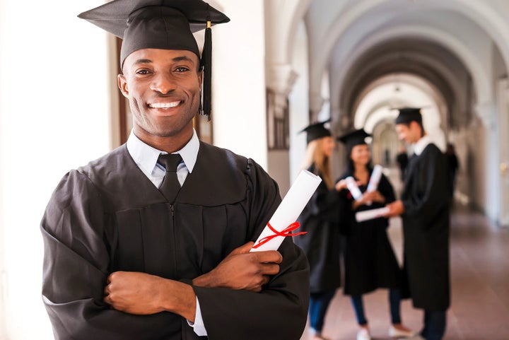 college graduate holding his diploma | Subaru of Gallatin in Gallatin TN